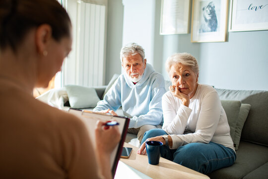Senior couple meeting advisor at home
