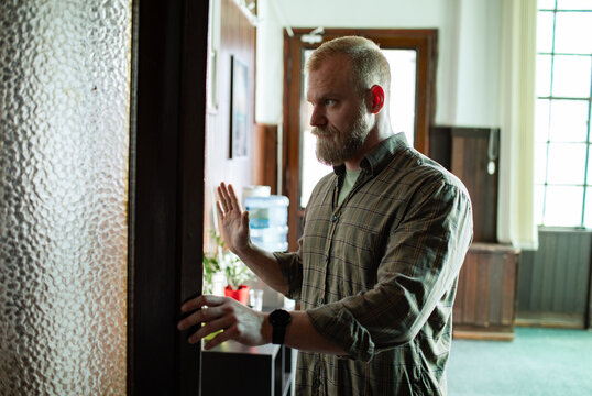 Mature man entering group therapy meeting room at community center