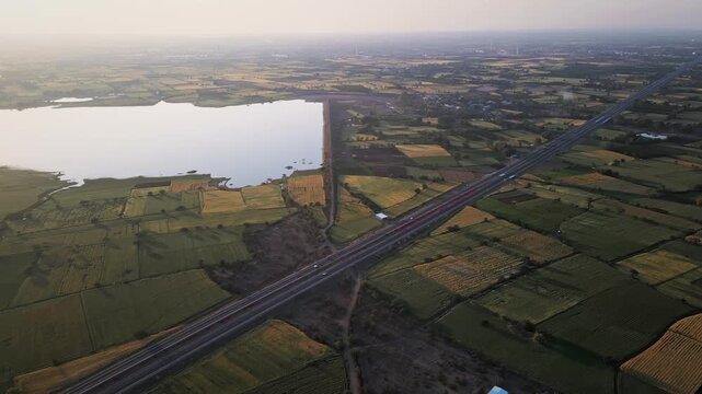 Aerial view of the Delhi&ndash;Mumbai Expressway, showcasing a modern multi-lane highway cutting through the landscape. The image highlights India&rsquo;s advanced infrastructure, smooth road network.