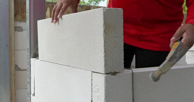Watch step-by-step process of stacking building blocks for construction projects.