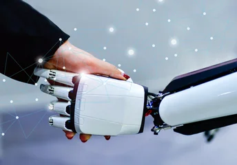 Advanced bionic robotic hand shaking hands with human, symbolizing AI and human collaboration. © I Viewfinder