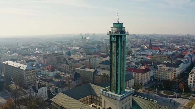 Up drone shot around ostrava city hall tower in summer