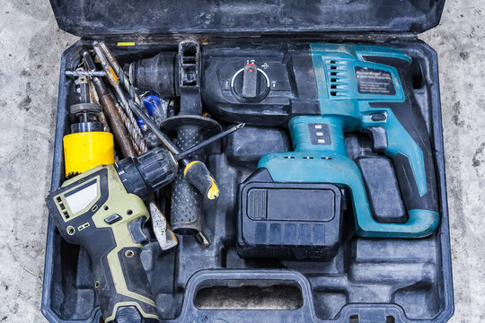 Cordless electric drills and accessories in an open tool kit, ready for DIY construction and repair work. The concept of repair or professional construction work.