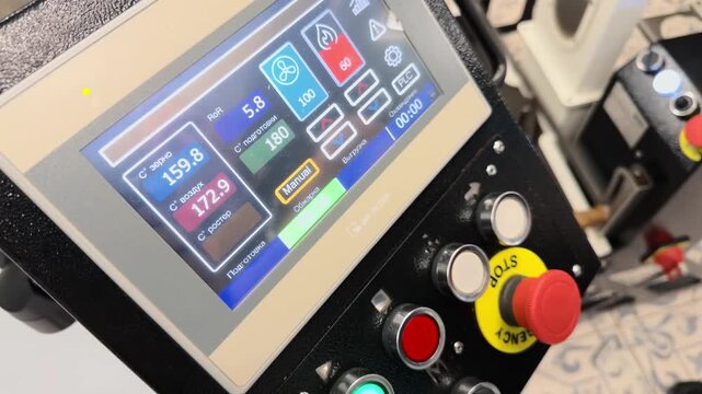 Close Up Handheld Shot of Industrial Coffee Roaster Control Panel Touchscreen Displaying Real Time Temperature Metrics and RoR Data with Operator Hand Adjusting Settings in Roastery Facility Scene