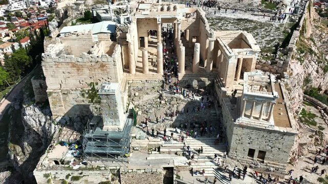 Aerial drone cinematic still video of iconic Propylea or gate of Acropolis hill and the Parthenon, Athens historic centre, Attica, Greece