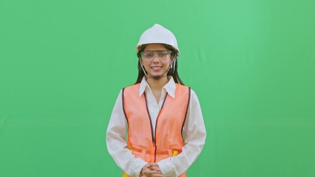 A female engineer pressing her palms together in an apologetic gesture for a protocol error. Representing responsibility and safety awareness on green screen.
