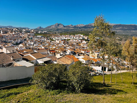 White houses of a white andalucian village in a valley under a clear blue sky. Colmenar, Malaga, Andalucia, Spain.