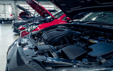 Auto repair shop. Cars open bonnet parked in garage for repair and maintenance service. Car check up at service station. Car waiting for inspection in auto repair shop. Car maintenance and checklist. © Fahroni