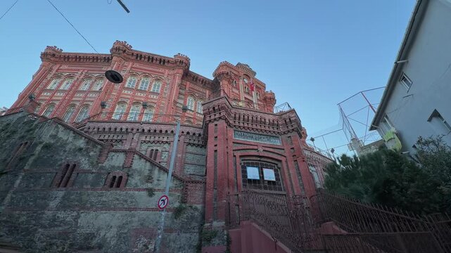A low-angle, 4K cinematic footage captures the majestic structure of the historic Phanar Greek Orthodox College (&Phi;&alpha;&nu;&alpha;&rho;&iota;ώ&tau;&iota;&kappa;&eta; &Mu;&epsilon;&gamma;ά&lambda;&eta; &tau;&omicron;&upsilon; &Gamma;έ&nu;&omicron;&upsilon;&sigmaf; &Sigma;&chi;&omicron;&lambda;ή) in Istanbul, Turkey, often referred to as 'The Red