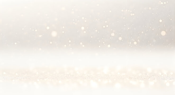 Soft golden bokeh lights and glitter particles shimmering on a bright white surface for a festive background isolated on white background