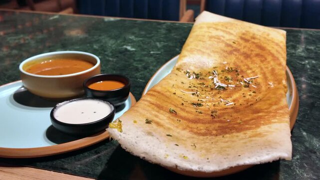 South Indian dosa with chutney and sambar served on plate, traditional Indian food