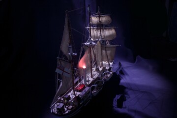 a sailing ship at sea under the moon © Standard