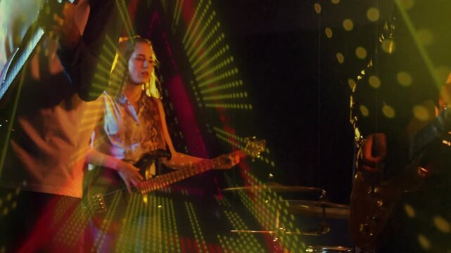 Singing frontman in raglan shirt, playing guitar on stage with vintage mic and green projection