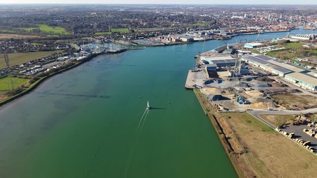 Aerial view of a yacht sailing into Ipswich Harbour on a sunny day