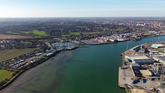 Aerial drone view of the Port of Ipswich and River Orwell industrial sites, showing Cliff Quay and West Bank logistics infrastructure in Suffolk, UK.