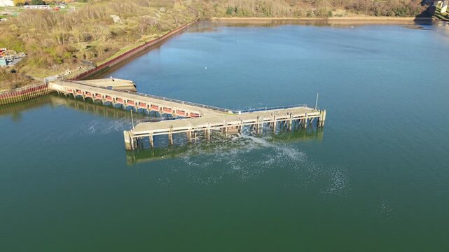 Aerial view of a wastewater treatment discharge point on a jetty into the River Orwell estuary in Ipswich UK