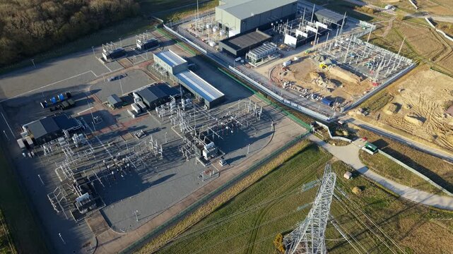 Aerial drone view of Bramford National Grid electrical substation with pylons and transformer components for energy grid security and stability UK