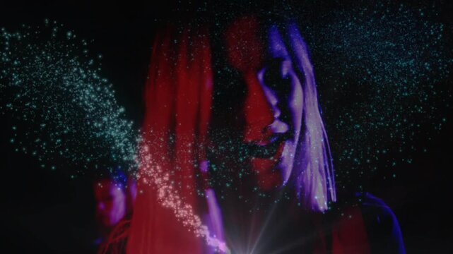Female singer singing under red purple light, spot emitting teal dots veiling face, enhancing music