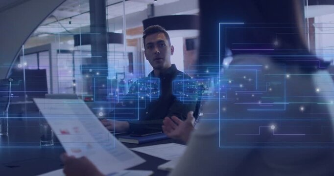 Holographic overlay appearing, woman shifting report, male leaning, nodding, reviewing data