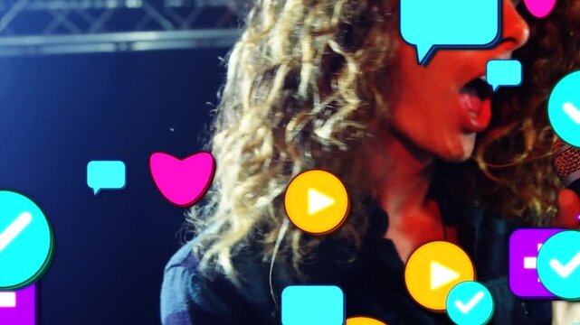 Vertical video: Lead singer gripping mic, singing music on stage, sparking social icons over singer