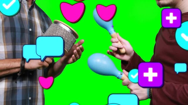 Duo playing cabasa and maracas on chroma sparking social media icons obscuring hands creating buzz