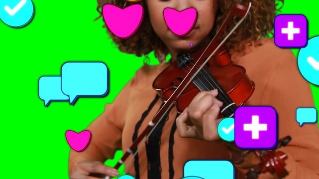 Playing violinist in striped top, bowing violin with bow, fingering in green chroma icons appearing