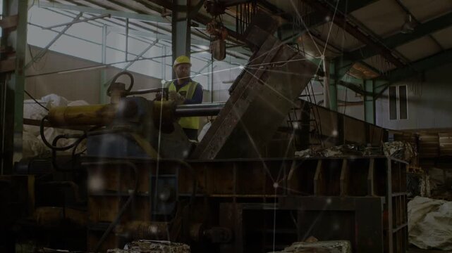Worker engaging controls, hydraulics extending and plate tilting, compacting pallets and sacks