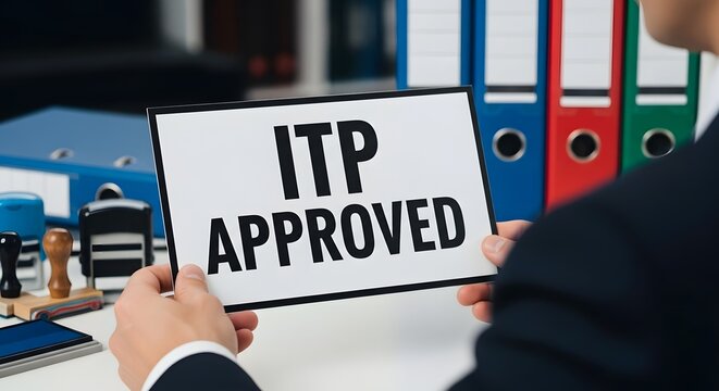 A businessman holding an ITP approved sign in office