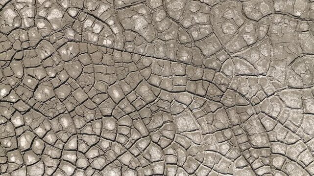 Aerial view of intricate cracked earth patterns and dry mud texture in Minas de Riotinto, Andalusia, Spain.
