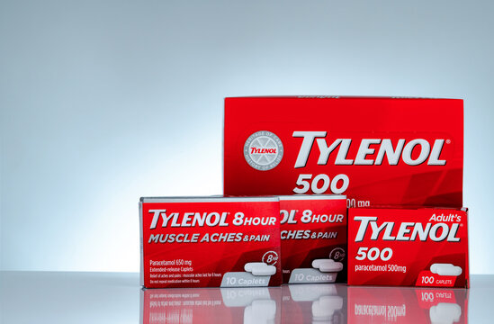 CHONBURI, THAILAND-OCTOBER 27, 2018 : Tylenol 500 mg and Tylenol 8 hour 650 extended-release caplets in red packaging on gradient background. Drug for relief pain, fever, muscle aches, and headache.