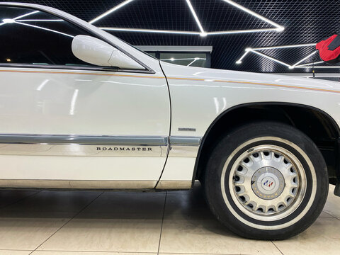 White Buick Park Avenue Roadster 1991 in showroom after the restoration. Exterior of the Buick Park Avenue in showroom. Vehicle exterior Classical American Vintage sedan Buick Park Avenue 1G. 