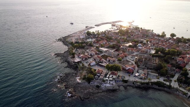Side Ancient City extends along a Mediterranean peninsula where the temples of Apollo and Athena, Roman theater and ancient harbor define a layered coastal landscape in Antalya, T&uuml;rkiye.