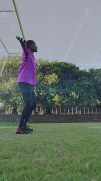 Vertical video: Soccer goalie lowering arms, shifting to ready by goal, markers appearing for saves