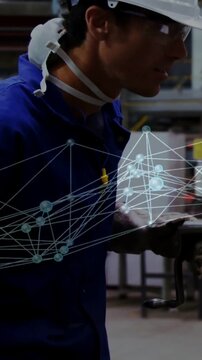 Factory worker using tool while camera tracking right, overlay hovering in front showing quality