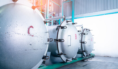 High pressure processing machine with stainless steel tank in modern food manufacturing factory, industrial equipment used for hydrostatic pasteurization eliminating pathogens. Safe food preservation.