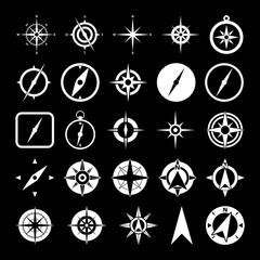 Compass and wind rose icons set isolated on black background © sljubisa
