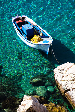 Traditional Greek fishing boat in crystal clear water, Kalotaritissa, Donoussa, Greece