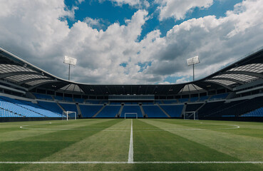 A vast stadium with empty seats under a partly cloudy sky during daytime © stock