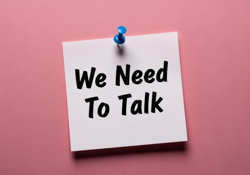 White sticky note with 'we need to talk' message with the message suggests an important conversation