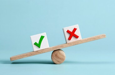 A wooden seesaw balances two blocks, one with a green checkmark and the other with a red cross against a light blue background.