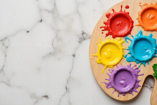 Colorful paint palette with vibrant acrylic colors and splashes for International Children's Day  