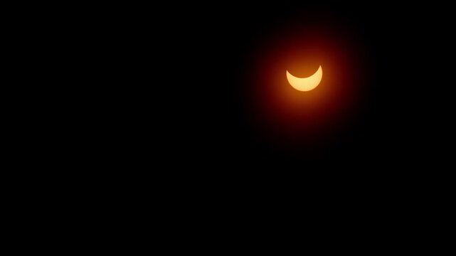 Spectacular footage of the partial solar eclipse on April 8, 2024. A bright crescent sun glows in the sky above Halifax, Nova Scotia, Canada, rare astronomical phenomenon captured in high detail 4K.