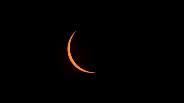 Aerial and ground view of the partial solar eclipse on April 8, 2024. Glowing crescent sun visible over Halifax, Nova Scotia, Canada during this special astronomical event 4K.