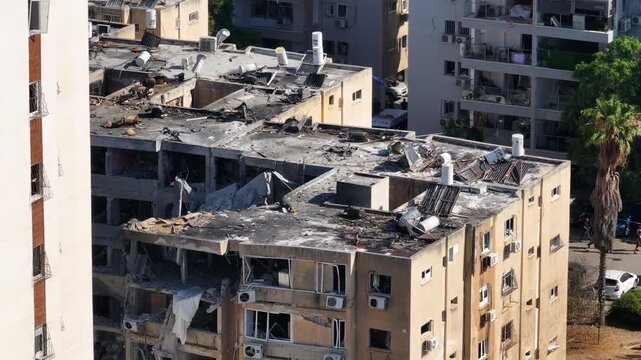 Aerial view Holon Iranian missile strike destruction Israel

Drone footage showing rescue teams at missile impact site in Holon residential area Israel June 14 2025

