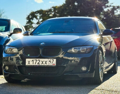 Black BMW 3 series V E 92 coupe in a parking lot. Motor car BMW M3 320d E92 2008 parked on street. Exterior of a German sport car BMW M3 E 92 coupe black color.