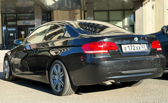 Black BMW 3 series V E 92 coupe in a parking lot. Motor car BMW M3 320d E92 2008 parked on street. Exterior of a German sport car BMW M3 E 92 coupe black color.