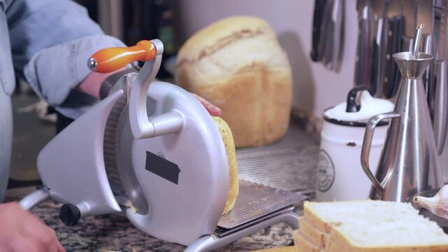 Cutting bread in kitchen
