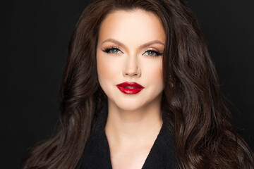 Fototapeta premium Luxurious young woman red lipstick, dark tonal portrait