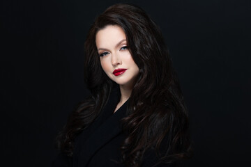 Fototapeta premium Stylish brunette red lipstick, dark studio elegance