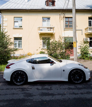  Nissan 370Z Nismo parked against residential building